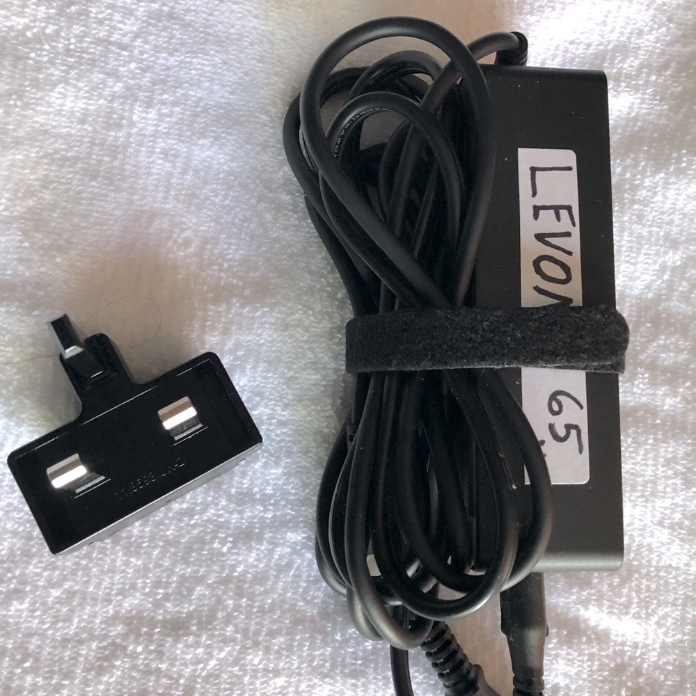 Levono 65W wall charger and small travel plug.